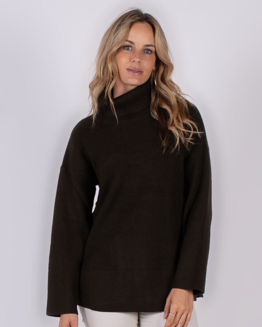 Vrouw draagt een donkerbruine coltrui met ribstructuur uit de Studio AW25-26 collectie.