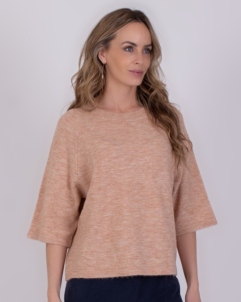 Vrouw draagt een losse trui met halve mouwen in de kleur Volos old pink.